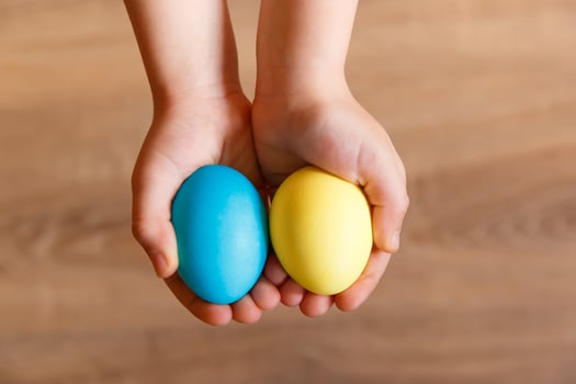 Paint eggs for Easter, bright Easter holiday, children paint eggs, colored eggs in a basket, colored eggs on a stand, Holiday background photo