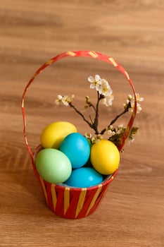 Paint eggs for Easter, bright Easter holiday, children paint eggs, colored eggs in a basket, colored eggs on a stand, Holiday background photo