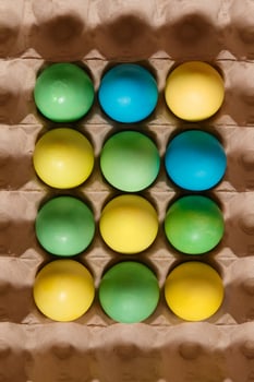 Paint eggs for Easter, bright Easter holiday, children paint eggs, colored eggs in a basket, colored eggs on a stand, Holiday background photo