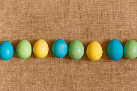 Paint eggs for Easter, bright Easter holiday, children paint eggs, colored eggs in a basket, colored eggs on a stand, Holiday background photo