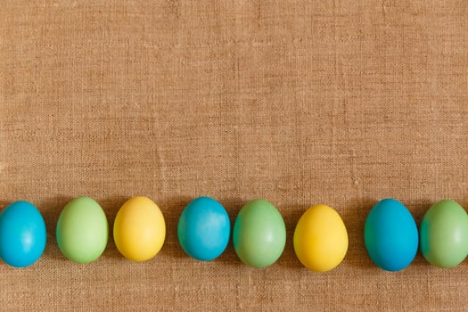 Paint eggs for Easter, bright Easter holiday, children paint eggs, colored eggs in a basket, colored eggs on a stand, Holiday background photo