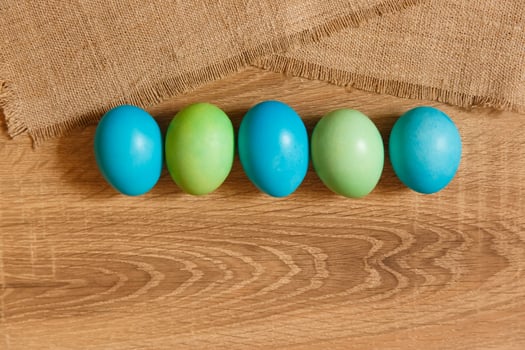 Paint eggs for Easter, bright Easter holiday, children paint eggs, colored eggs in a basket, colored eggs on a stand, Holiday background photo