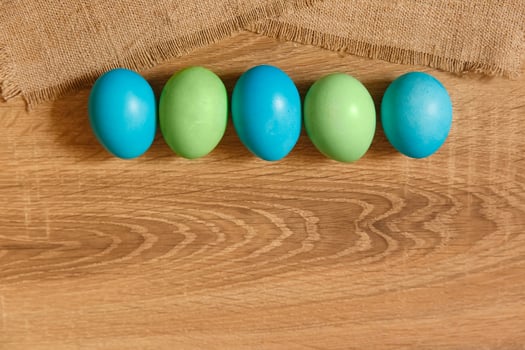 Paint eggs for Easter, bright Easter holiday, children paint eggs, colored eggs in a basket, colored eggs on a stand, Holiday background photo