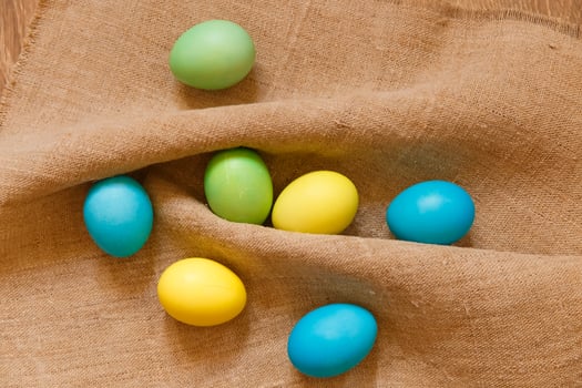 Paint eggs for Easter, bright Easter holiday, children paint eggs, colored eggs in a basket, colored eggs on a stand, Holiday background photo