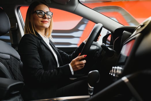Young business woman driving in her car to work. Successful business concept. business woman driving photo