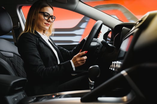 Young business woman driving in her car to work. Successful business concept. business woman driving photo