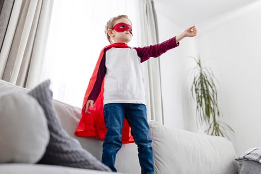 Young boy in superhero costume playing at home. photo