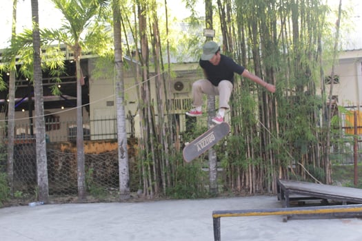 Indonesia - Medan 17 August 2023 an asian man doing skateboard tricks on a ramp photo
