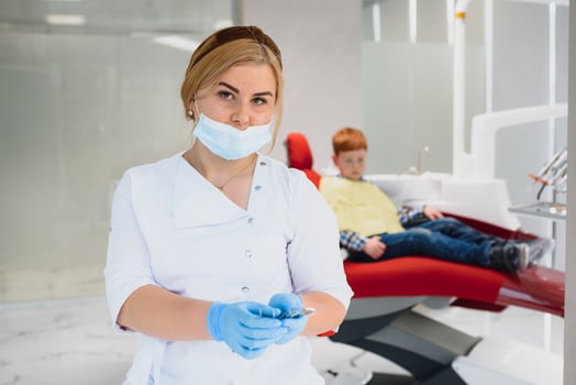 Female dentist and child in a dentist office photo