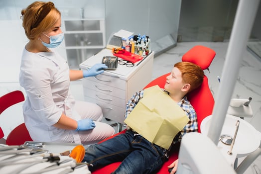 Boy satisfied with the service in the dental office. concept of pediatric dental treatment photo