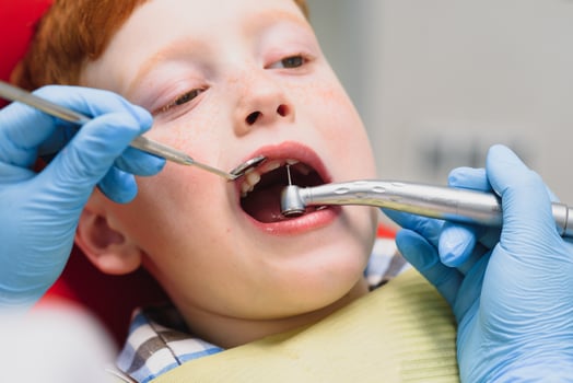 Female dentist and child in a dentist office photo