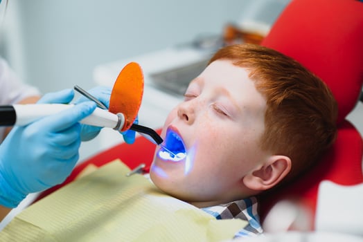 Boy satisfied with the service in the dental office. concept of pediatric dental treatment photo