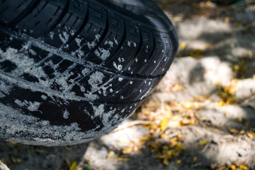 A rubber tire covered by sand, macro shot. photo
