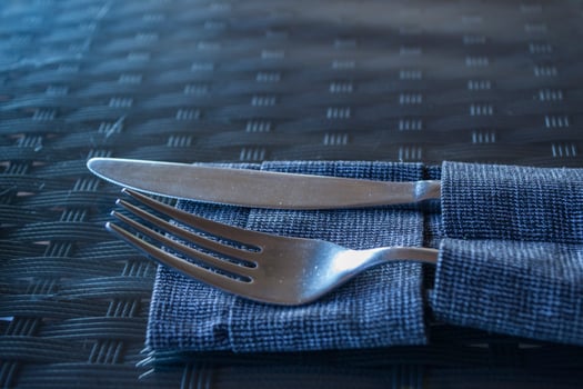 A fork and a knife on the dining table. photo