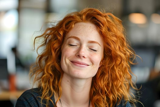 AI generated A candid portrait of a woman with curly red hair and freckles, her eyes closed in laughter, exuding happiness and carefree energy photo