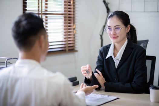 Real estate agent agree to buy a home and give key to client at agency office. Concept agreement photo