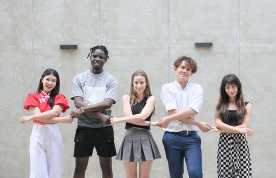 Group of young multiethnic friend having fun and laughing outdoors on beautiful summer day photo