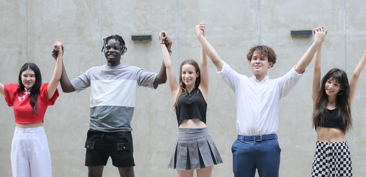 Group of young multiethnic friend having fun and laughing outdoors on beautiful summer day photo