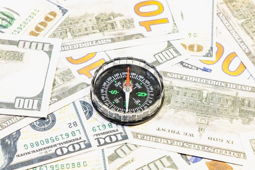 American currency banknote American dollars as a symbol of prosperity and success in business and affairs with a compass pointing west photo