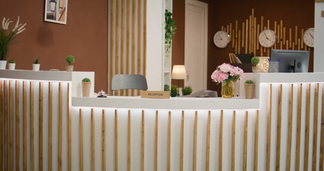 Lounge area with luxury couch in hotel decorated with classy stylish furniture, elegant interior design and decorations. Empty reception with front desk and marble floors in resort entrance. photo