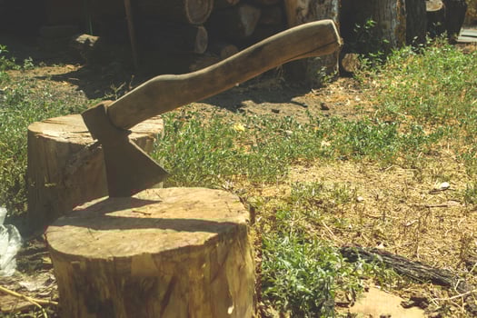An axe in the wooden stump. photo