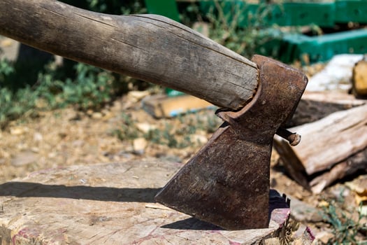 An axe in the wooden stump. photo