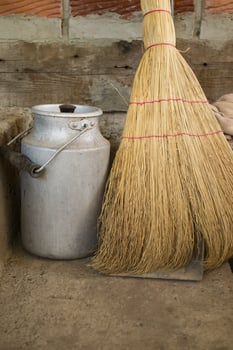 The milk jar and broom. Retro style. photo