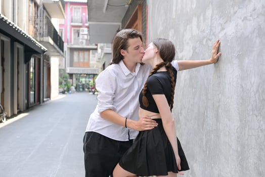 A couple is enjoying a summer vacation in the community streets, happily showing their love to each other. photo