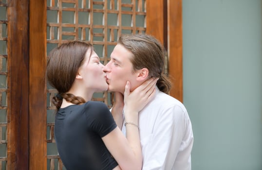 A couple is enjoying a summer vacation in the community streets, happily showing their love to each other. photo