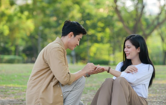 LGBT couple is enjoying a summer vacation in the park, happily showing their love to each other. photo
