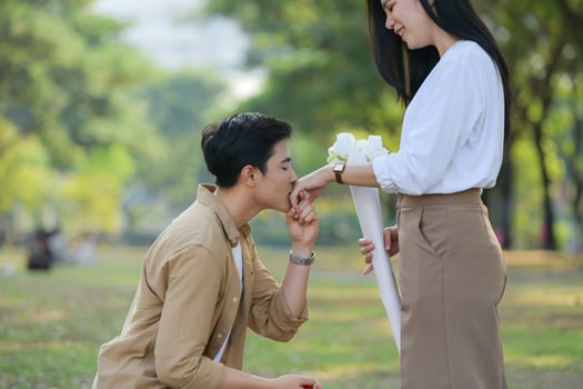 LGBT couple is enjoying a summer vacation in the park, happily showing their love to each other. photo