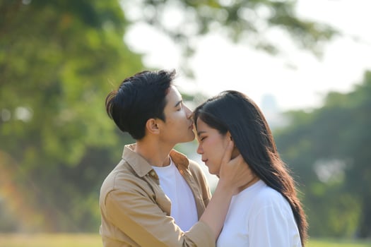 LGBT couple is enjoying a summer vacation in the park, happily showing their love to each other. photo