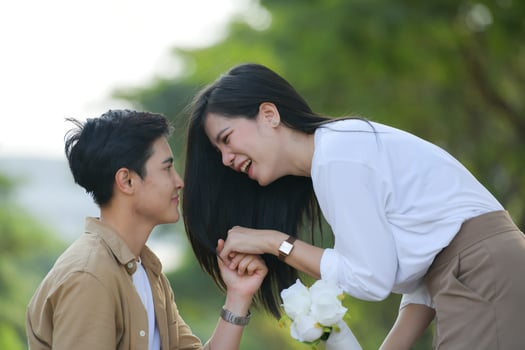 LGBT couple is enjoying a summer vacation in the park, happily showing their love to each other. photo