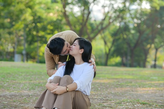 LGBT couple is enjoying a summer vacation in the park, happily showing their love to each other. photo