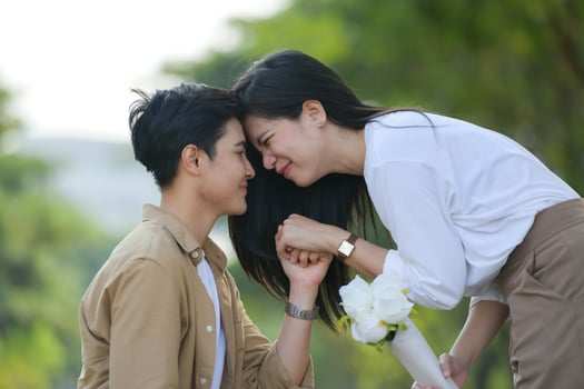 LGBT couple is enjoying a summer vacation in the park, happily showing their love to each other. photo