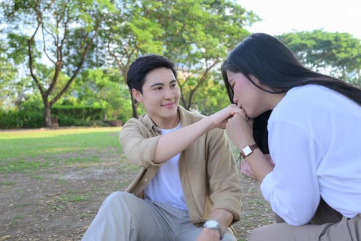 LGBT couple is enjoying a summer vacation in the park, happily showing their love to each other. photo
