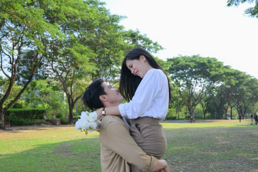 LGBT couple is enjoying a summer vacation in the park, happily showing their love to each other. photo
