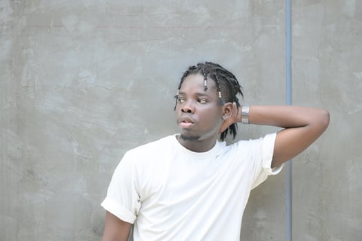 A young man with his hairstyle and the atmosphere of living in the community. photo