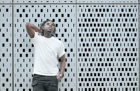 A young man with his hairstyle and the atmosphere of living in the community. photo