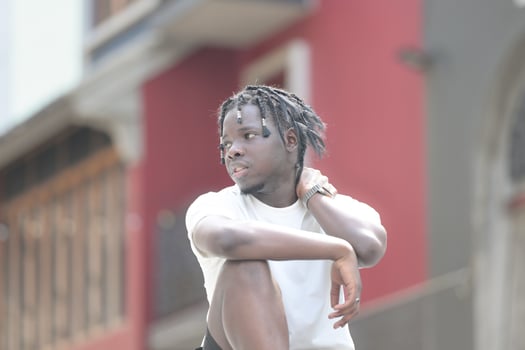 A young man with his hairstyle and the atmosphere of living in the community. photo
