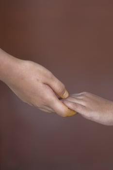 mother holding her child's hand photo