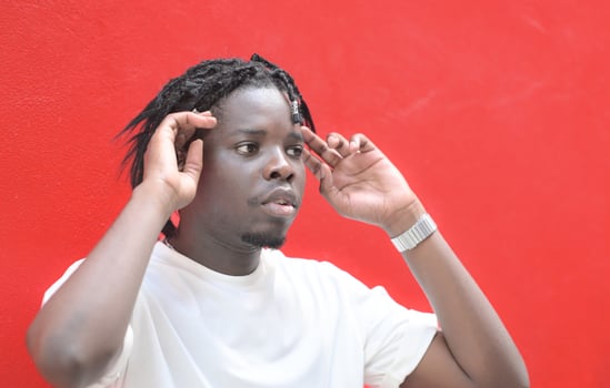 A young man with his hairstyle and the atmosphere of living in the community. photo