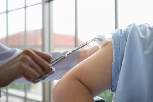 Doctor using syringe give the injection to the patient photo