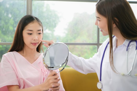A beauty doctor explains cosmetic surgery and post-operative care. photo