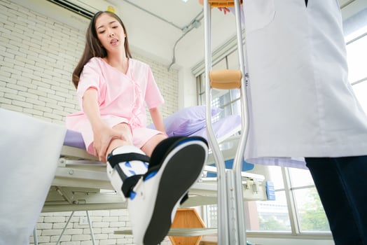 Following a period of treatment, the doctor examines the patient's legs and knees. photo