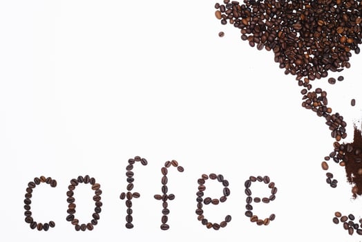 Word coffee made from coffee beans isolated on white background photo