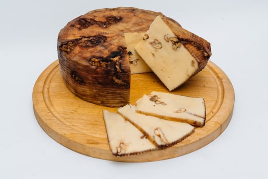 Isolated Holland Gouda cheese with walnuts on a white background photo