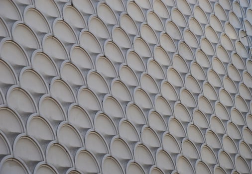 Texture of gray marble stone wall facade, tiles with round elements. photo