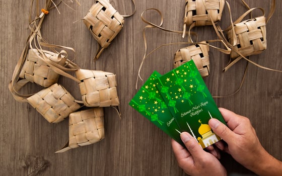 Hand holding Money envelop for muslim Eid celebration photo