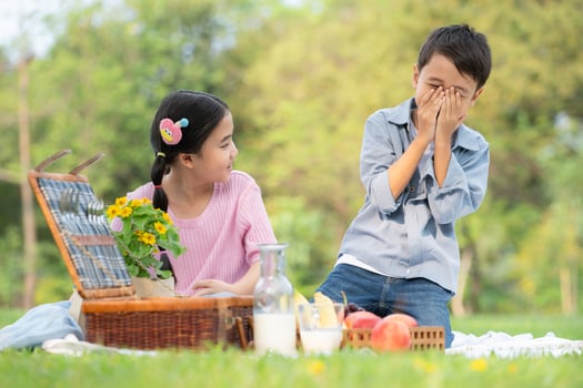 Happy family enjoying a picnic in the park, Children sitting back to back and reading books. photo